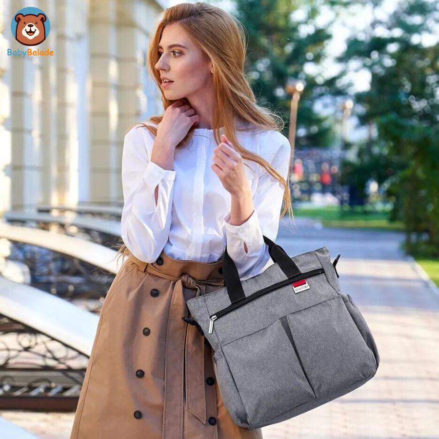sac à langer bandoulière porté sur les bras