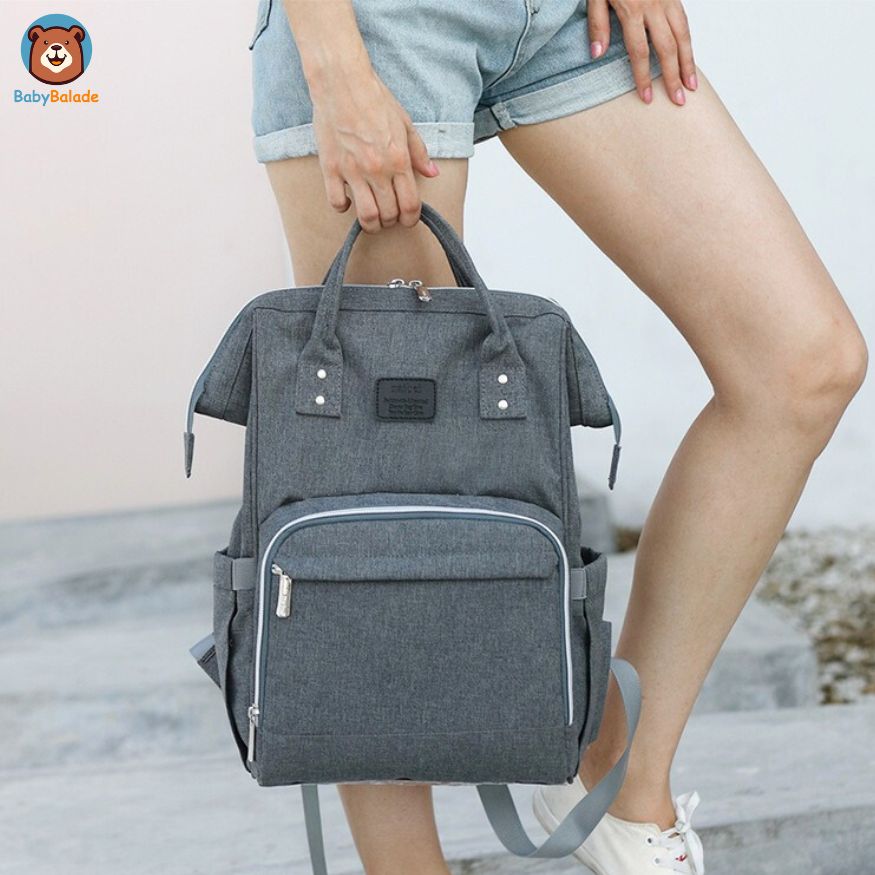 sac à dos à langer porté comme un sac classique